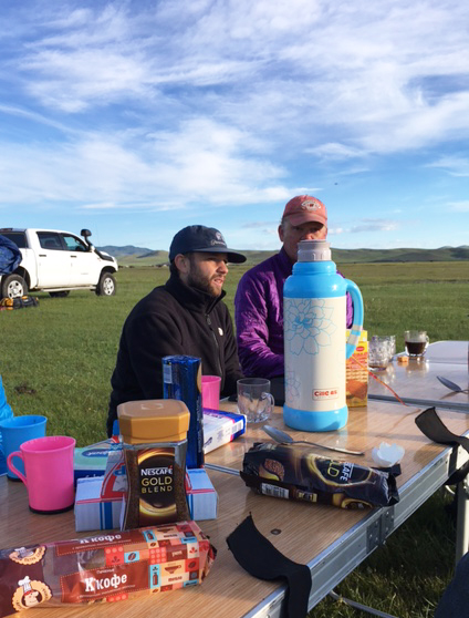 Kevin Stark and Scott Travis having breakfast on the first morning outside of Ulaanbaatar. Instant coffee and biscuits are a staple of the mornings on the road. (Destiny Washington/Gary Comer College Prep) 