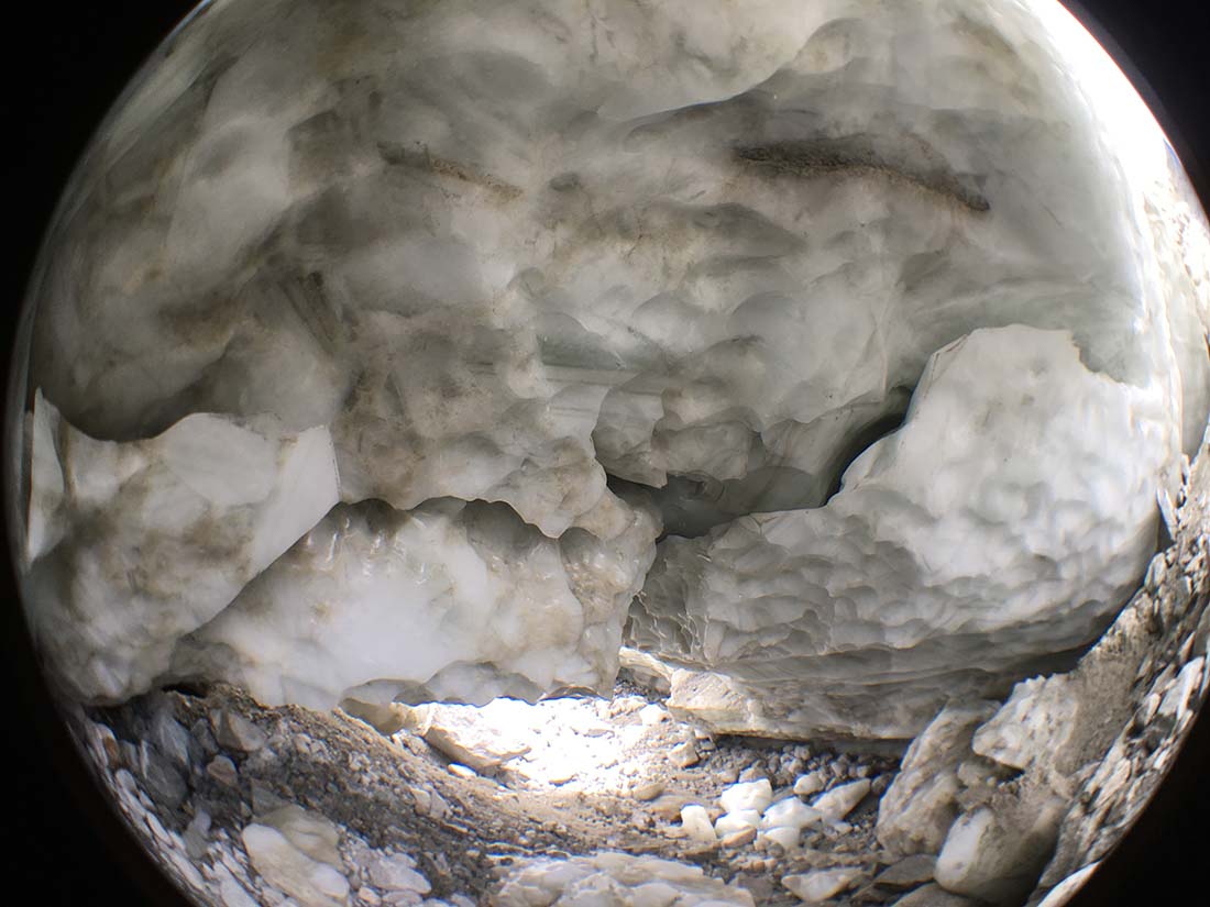 Glacial meltwater carved this cave into the Potanin Glacier. The caves can be dangerous in the summer months when ice can break off without warning. (Kevin Stark / Medill)