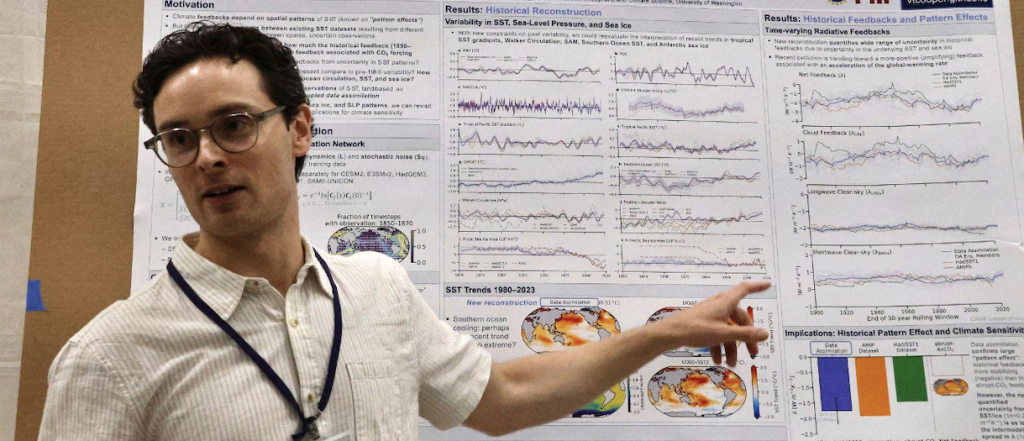 Vince Cooper points to a graph during his poster presentation at the Comer Climate Conference.